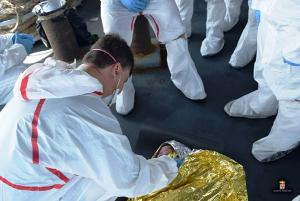 Italian navy personnel gather around a baby rescued&nbsp;&hellip;