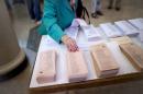 A woman chooses her ballots in Spain's municipal and regional elections at a polling station in Madrid on May 24, 2015