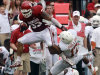Oklahoma fullback Trey Millard (33) breaks a tackle against Texas cornerback Adrian Phillips (17) and defensive back Mykkele Thompson (2) during the first half of an NCAA college football game at the Cotton Bowl Saturday, Oct. 13, 2012, in Dallas. (AP Photo/Michael Mulvey)