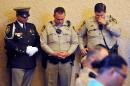 Las Vegas police bow their heads during a memorial service for Joseph Wilcox at Palm Downtown Mortuary on Sunday, June 22, 2014, in Las Vegas. Wilcox went for his own legal and concealed handgun after a couple killed Officers Igor Soldo and Alyn Beck at a nearby pizza shop and walked into a Wal-Mart, fired a shot in the air, and declared the start of a revolution two weeks ago. (AP Photo/Las Vegas Review-Journal, David Becker, Pool)