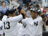 New York Yankees' Robinson Cano, right, celebrates with Alex Rodriguez, left, after Cano hit a grand slam during the fifth inning of a baseball game against the Oakland Athletics Thursday, Aug. 25, 2011 at Yankee Stadium in New York. (AP Photo/Bill Kostroun)