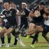 New Zealand's DJ Forbes and Lote Raikabula look on as teammate Ben Lam fights for the ball against Samoa's Levi Asifa'amatala during their Sevens World Series Cup final rugby match at The Sevens stadium in Dubai