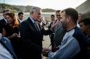 French Foreign Minister Jean-Marc Ayrault (C) met with Syrian refugees in southeastern Turkey, during a trip in which he indirectly warned Russia against vetoing a UN resolution condeming the use of chemical weapons in Syria