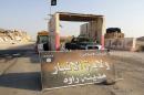 In this Tuesday, July 22, 2014 photo, a sign is posted at a checkpoint belonging to the Islamic State group, captured from the Iraqi Army, at the main entrance of Rawah, 175 miles (281 kilometers) northwest of Baghdad, Iraq. Arabic reads,"Islamic State, the Emirate of Anbar, City of Rawah." It has been nearly six weeks since a Sunni militant blitz led by the Islamic State extremist group seized large swaths of northern and western Iraq. (AP Photo) (AP Photo)