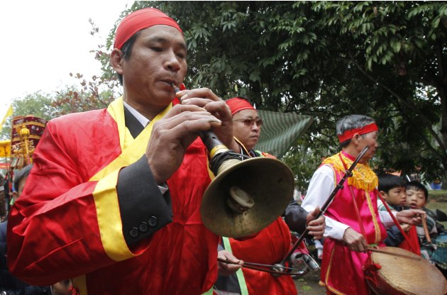 Villagers play traditional music as they take part in a festival at the Nem Thuong village in Bac Ninh