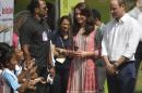 The Duke and Duchess of Cambridge, Prince William, and his wife, the former Kate Middleton listen to Indian children sing a song during a charity event at the Oval Maidan in Mumbai, India, Sunday, April 10, 2016. The royal couple began their weeklong visit to India and Bhutan, by laying a wreath at a memorial Sunday at Mumbai's iconic Taj Mahal Palace hotel, where 31 victims of the 2008 Mumbai terrorist attacks were killed. (Rafiq Maqbool /Pool via AP)