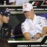 Red Bull Formula One driver Vettel talks with Schumacher during a news conference at the Interlagos racetrack in Sao Paulo