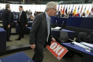 European Commission President Juncker holds a placard …