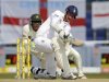 England's Broad hits out at bowling of Pakistan's Rehman as Akmal looks on during the second cricket test match at the Sheikh Zayed Stadium in Abu Dhabi
