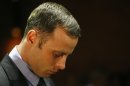 FILE - In this Feb. 21, 2013 file photo, Olympic athlete Oscar Pistorius stands during his bail hearing at the magistrate court in Pretoria, South Africa A judge in South Africa says Pistorius, who is charged with murdering his girlfriend, can leave South Africa to compete in international competition, with conditions. (AP Photo/Themba Hadebe, File)