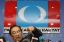Malaysia's opposition leader Ibrahim gestures during a news conference at his party's headquarters in Petaling Jaya, outside Kuala Lumpur
