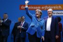 Kauder parliamentary floor leader of CDU and German Chancellor Merkel celebrate after first exit polls in German general election at party headquarters in Berlin