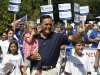 Republican presidential candidate, former Massachusetts Gov. Mitt Romney, carries his granddaughter Soleil, 3, as he participates in the Fourth of July Parade in Wolfeboro, N.H., Wednesday, July 4, 2012. (AP Photo/Charles Dharapak)