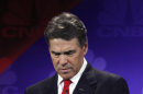 FILE - In this Nov. 9, 2011 file photo, then-Republican presidential candidate Texas Gov. Rick Perry looks at his notes during a Republican Presidential Debate at Oakland University in Auburn Hills, Mich. The Republican primary campaign is already fading into memory. Remember Herman Cain's 9-9-9 tax plan? Newt Gingrich's 