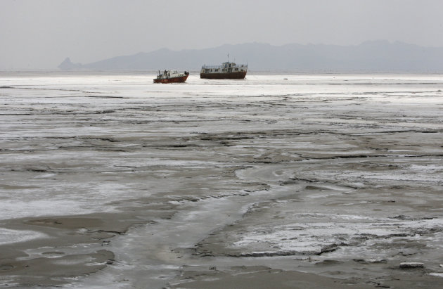 An abandoned boat and an abandoned ship are stuck in the solidified salts of the Oroumieh Lake, some 370 miles (600 kilometers) northwest of the capital Tehran, Iran, Friday, April 29, 2011. (AP Photo