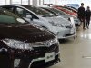 Visitors look at Toyota Motor Corp's hybrid cars at the company's showroom in Tokyo