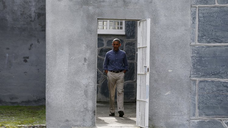 U.S. President Obama tours the cell block on Robben Island where Nelson Mandela was held captive near Cape Town