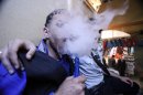 FILE - In this Wednesday, March 7, 2012 file photo Iraqis who identify themselves as so-called Emos smoke a traditional 