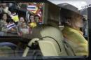 Well-wishers wave flags and pray as Thailand's King Bhumibol Adulyadej leaves Siriraj hospital in Bangkok