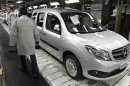 French carmaker Renault employees stand next to a Mercedes Benz Citan based on a Renault Kangoo van at the Renault factory in Maubeuge