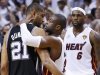 Heat's Wade hugs Spurs' Duncan as the Heat's James approaches after the Heat defeated the Spurs to win Game 7 of their NBA Finals basketball playoff in Miami