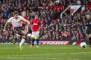 Liverpool's Steven Gerrard, right, fails to score his third penalty against Manchester United during their English Premier League soccer match at Old Trafford Stadium, Manchester, England, Sunday March 16, 2014. (AP Photo/Jon Super)