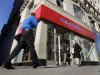 People pass a Bank of America brach, in New York,  Monday, Jan. 7, 2013. Bank of America will pay $10.3 billion to the government mortgage agency Fannie Mae to settle claims resulting from mortgage-backed investments that soured during the housing crash.  (AP Photo/Richard Drew)