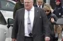Toronto mayor Rob Ford and his wife Renata leave the public memorial for police constable John Zivcic in Toronto