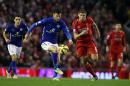 Leicester City's David Nugent, left, and Liverpool's Steven Gerrard battle for the ball during the English Premier League soccer match at Anfield, Liverpool, England, Thursday Jan. 1, 2015. (AP Photo/PA, Peter Byrne) UNITED KINGDOM OUT NO SALES NO ARCHIVE