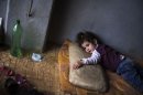 Rada Hallabi, 4, who is sick with diabetes, lies on a blanket in a refugee camp on the border with Turkey, near Azaz village, Syria, Sunday, Sept. 30, 2012. (AP Photo / Manu Brabo)