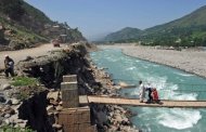 File picture. A Pakistani family crosses the River Swat by bridge at the hill station of Madyan. Italian archaeologists say they have discovered a cemetery that reveals complex funeral rites dating back more than 3,000 years in Pakistan's Swat valley, which was recently controlled by the Taliban
