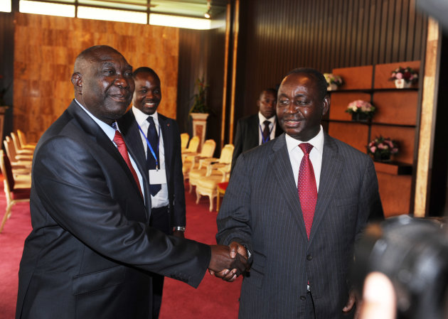 Central African Republic President Francois Bozize, right, shakes hands with Michel Djotodia, leader of the Seleka rebel alliance, during peace talks in Libreville, Gabon, Friday, Jan. 11, 2013. Officials say that the rebel group controlling much of the northern half of the country have agreed to enter into a coalition with the government. The deal will allow President Francois Bozize to stay in office until his current term expires in 2016.(AP Photo/Joel Bouopda Tatou)
