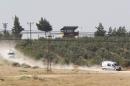 Ambulances leave from the Dag military post, which was attacked by Islamic State militants on Thursday, on the Turkish-Syrian border near Kilis, Turkey,