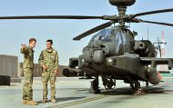 Britain's Prince Harry, left, is shown the Apache helicopter by a member of his squadron (name not provided) at Camp Bastion in Afghanistan, Friday Sept. 7, 2012. Prince Harry will be based at Camp Bastion during his tour of duty as a co-pilot gunner, returning to Afghanistan to fly attack helicopters in the fight against the Taliban. (AP Photo/John Stillwell)