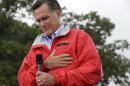Republican presidential candidate, former Massachusetts Gov. Mitt Romney puts his hand on his heart during a moment of silence for the embassy officials killed in Libya, as he campaigns in the rain at Lake Erie College in Painesville, Ohio, Friday, Sept. 14, 2012. (AP Photo/Charles Dharapak)
