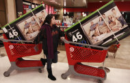 <p>               FILE - In this Nov. 25, 2011 file photo, a Target customer guides her shopping carts with televisions purchased at a Target Store in Colma, Calif. Consumers took on a lot more debt in December, charging more on their credit cards and pushing up debt in the category that covers auto loans and student loans by a hefty amount. (AP Photo/Jeff Chiu, File)
