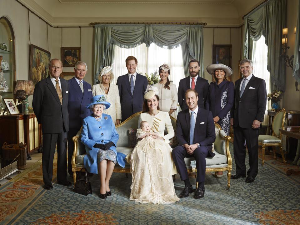 This image made available by Camera Press shows the official christening photo of Britain's Prince George photographed in the Morning Room at Clarence House in London on Wednesday Oct. 23, 2013. Kate Duchess of Cambridge holds her son Prince George seated next to Queen Elizabeth II and Prince William, back row from left, Prince Philip, Prince Charles, and the Duchess of Cornwall, Prince Harry, Pippa Middleton, James Middleton, Carole Middleton and Michael Middleton. (AP Photo/Jason Bell, Camera Press)