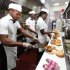 In this photo taken, Wednesday, Jan. 23, 2013 workers prepare hamburgers   at Johnny Rockets restaurant in Lagos, Nigeria. As Nigeria’s middle class grows along with the appetite for foreign brands in Africa’s most populous nation, more foreign restaurants and lifestyle companies are entering the country. And the draw on Nigerians’ new discretionary spending has also put new expectations on providing quality service in a nation where many have grown accustomed to expecting very little. ( AP Photo/Sunday Alamba)
