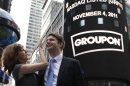 Groupon CEO Andrew Mason poses with his wife Jenny Gillespie outside the Nasdaq Market following his company's IPO in New York