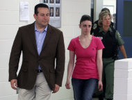 Casey Anthony, front right, walks out of the Orange County Jail with her attorney Jose Baez, left, during her release in Orlando, Fla., early Sunday, July 17, 2011. Anthony was acquitted last week of murder in the death of her daughter, Caylee. (AP Photo/Red Huber, Pool)