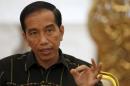 Indonesian President Joko Widodo gestures while speaking with Reuters during an interview at the presidential palace in Jakarta, Indonesia