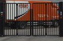 FILE - In this Feb. 21, 2012 file photo a TNT delivery truck is seen behind a closed gate in Hoofddorp, near Amsterdam, Netherlands. United Parcel Service Inc. has ditched its euro5.2 billion (US$6.9 billion) takeover of TNT Express NV after learning that European regulators would reject the deal in its current form. (AP Photo/Peter Dejong, File)
