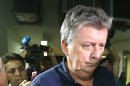 Ray Whelan, a longstanding director and project manager within the MATCH group, arrives at a police station after been arrested, in Rio de Janeiro, Brazil, Monday, July 7, 2014. Whelan, a senior executive with the official World Cup corporate hospitality provider was arrested Monday in the plush beachside hotel, as part of a Brazilian police investigation into illegal ticket sales. (AP Photo/STR)