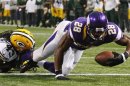 Minnesota Vikings' Peterson scores a touchdown past Green Bay Packers' Jennings on a seven-yard carry during their NFL football game in Minneapolis