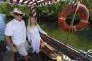 Lance Holmquist and his wife Suzanne pilot The African Queen vessel down canal in Key Largo