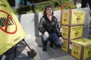 Katy Butler, 17, a high school student, from Ann Arbor, Mich., poses by the petitions she delivered to the Motion Picture Association of America, Wednesday March 7, 2012, in Los Angeles. Butler is urging the MPAA to change the 