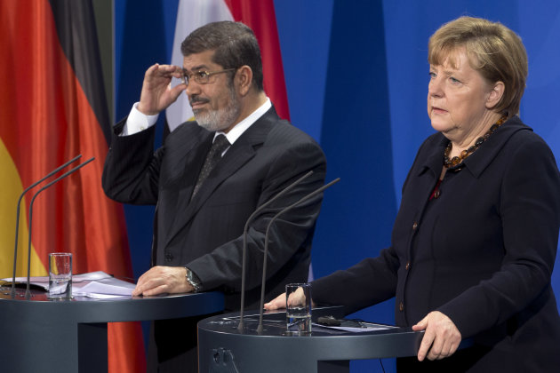 German Chancellor Angela Merkel, right, and President of Egypt Mohammed Morsi, left, address the media during a joint press conference after a meeting at the chancellery in Berlin, Germany, Wednesday, Jan. 30, 2013. (AP Photo/Michael Sohn)