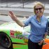 Journalist and television personality Katie Couric waves as she walks away from a car that she rode laps with race car driver Danica Patrick at the Indianapolis Motor Speedway in Indianapolis, Tuesday, July 10, 2012.  (AP Photo/Michael Conroy)