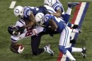 Houston Texans' Andre Johnson (80) is tackled by Indianapolis Colts' Jerrell Freeman (50), Vontae Davis (23) and Joe Lefeged (35) during the second half of an NFL football game, Sunday, Dec. 30, 2012, in Indianapolis. (AP Photo/AJ Mast)