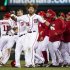 Washington Nationals right fielder Jayson Werth (28) escapes from his teammates after being rushed for hitting the game-winning single during the 13th inning of a baseball game against the Cincinnati Reds on Friday, April 13, 2012, in Washington. The Nationals won 2-1. (AP Photo/Evan Vucci)